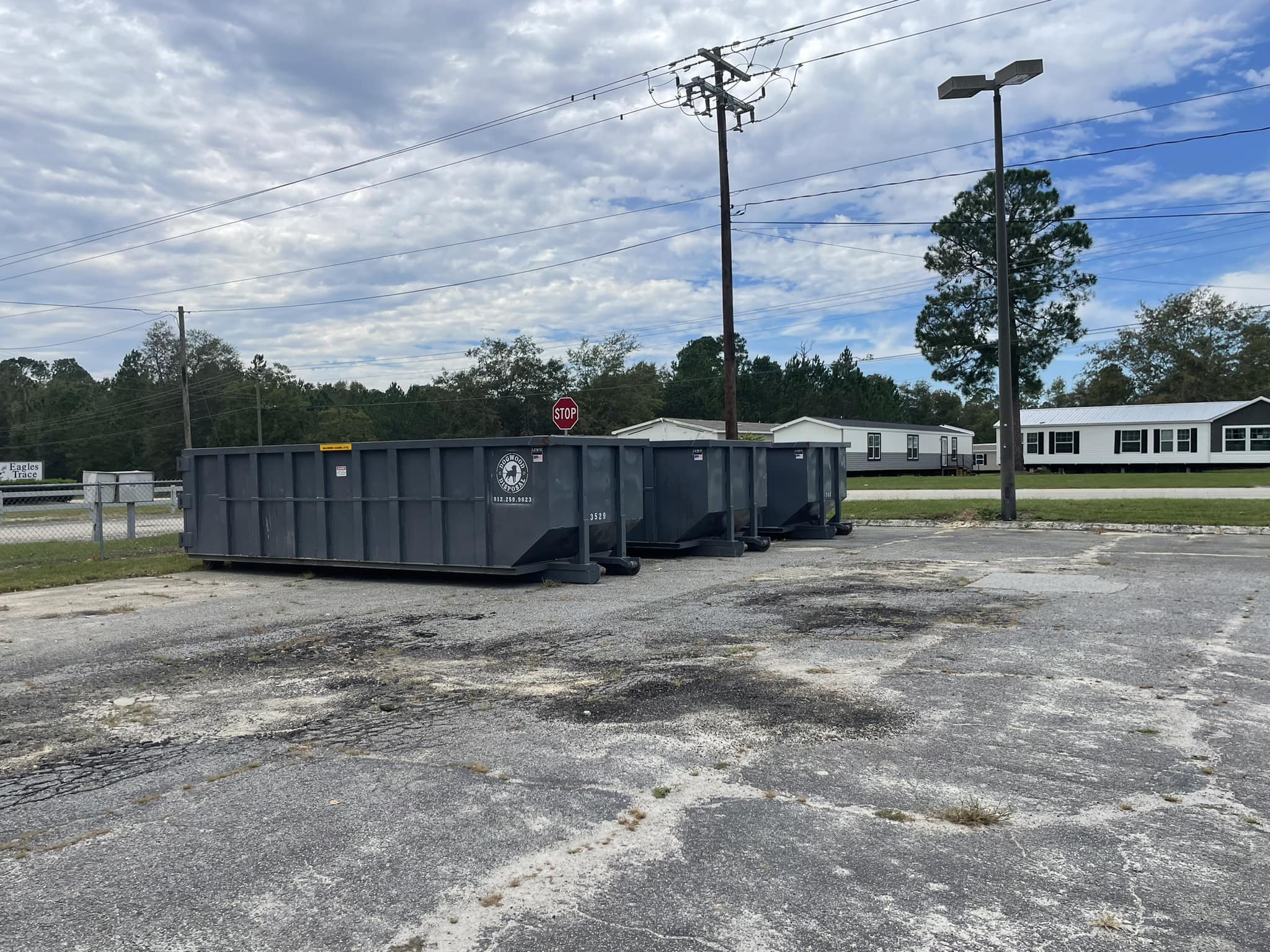 Dogwood Disposal red roll-off truck staged for delivery in Pooler Georgia subdivision