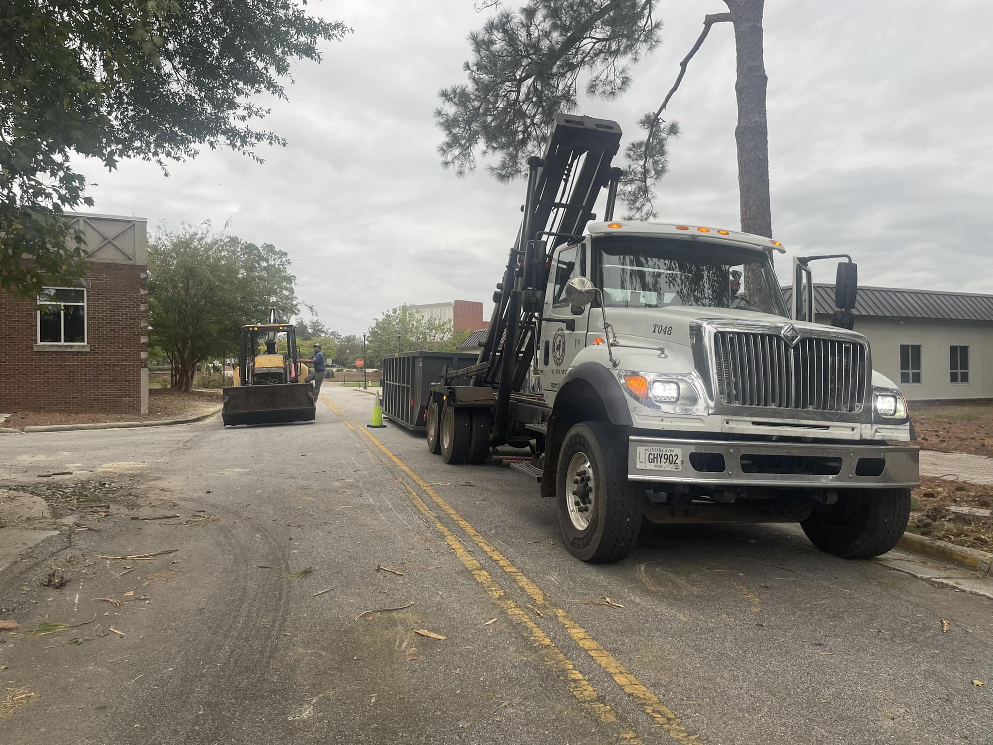 Dogwood Disposal roll-off dumpster placed for Metter Georgia property cleanup at dusk