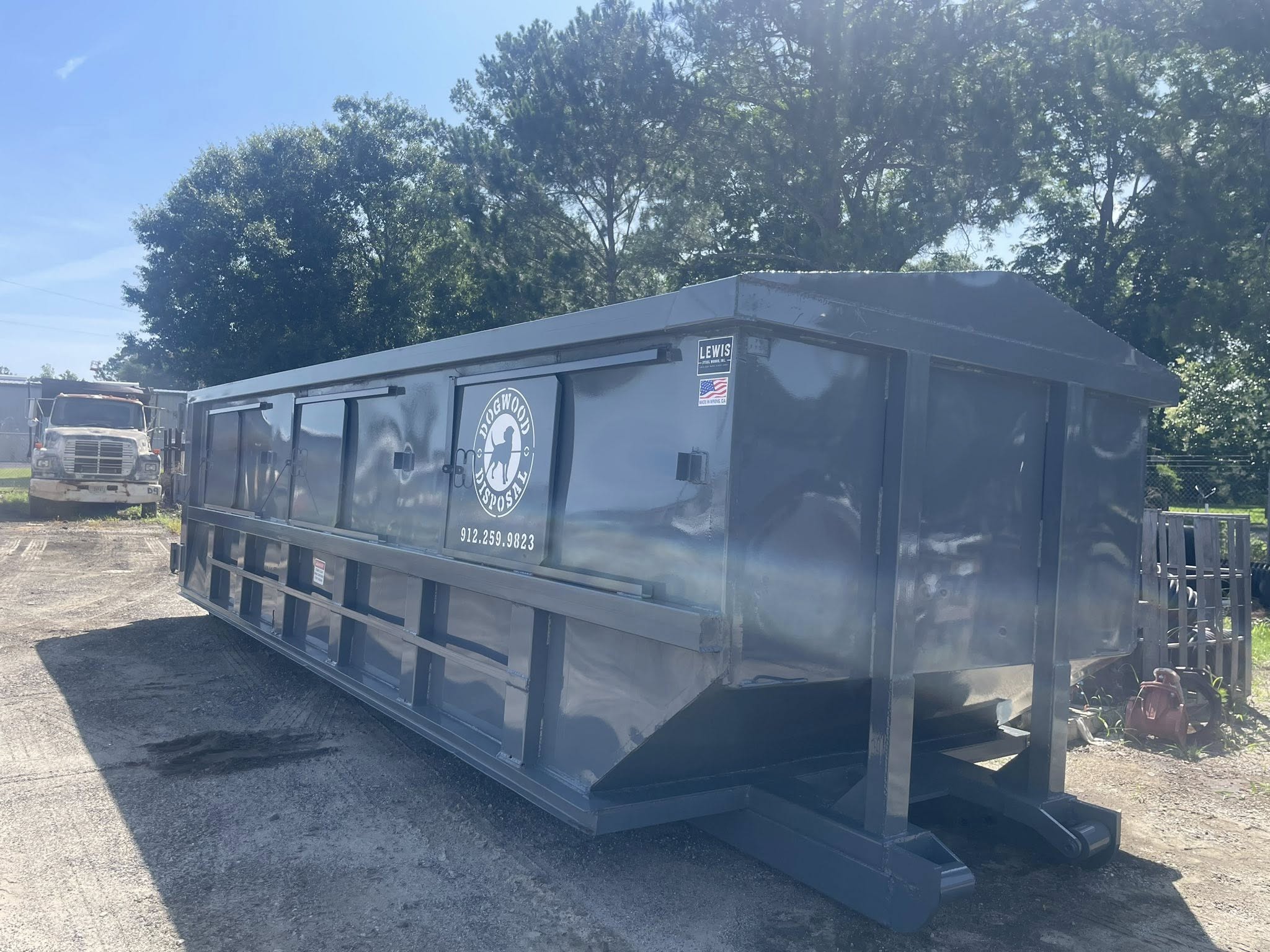 Dogwood Disposal red Peterbilt truck and roll-off dumpster ready for delivery in Statesboro Georgia